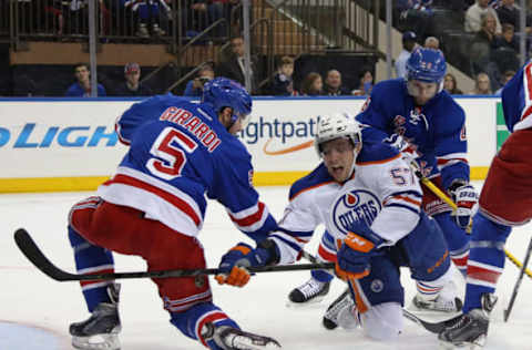 NEW YORK, NY – NOVEMBER 09: Dan Girardi #5 and Martin St. Louis #26 of the New York Rangers defend against David Perron #57 of the Edmonton Oilers during the first period at Madison Square Garden on November 9, 2014 in New York City. (Photo by Bruce Bennett/Getty Images)