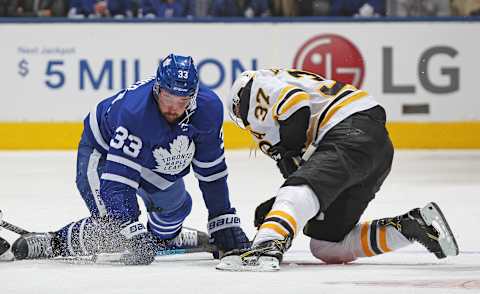 TORONTO, ON – OCTOBER 19: Patrice Bergeron #37 of the Boston Bruins battles against Frederik Gauthier #33 of the Toronto Maple Leafs during an NHL game at Scotiabank Arena on October 19, 2019 in Toronto, Ontario, Canada. The Maple Leafs defeated the Bruins 4-3 in overtime. (Photo by Claus Andersen/Getty Images)