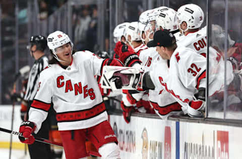 ANAHEIM, CALIFORNIA – NOVEMBER 18: Ethan Bear #25 of the Carolina Hurricanes celebrates at the bench after scoring a goal during the first period of a game against the Anaheim Ducks at Honda Center on November 18, 2021, in Anaheim, California. (Photo by Sean M. Haffey/Getty Images)