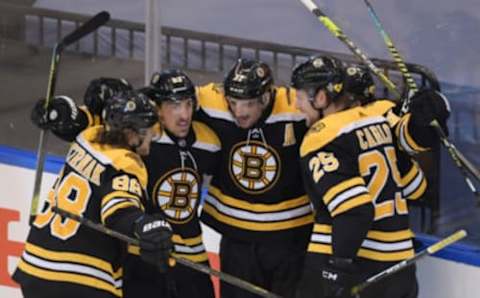 Aug 12, 2020; Toronto, Ontario, CAN; Boston Bruins center Patrice Bergeron (37) celebrates with teammates after scoring the game-winning goal against the Carolina Hurricanes in the second overtime in game one of the first round of the 2020 Stanley Cup Playoffs at Scotiabank Arena. Mandatory Credit: Dan Hamilton-USA TODAY Sports