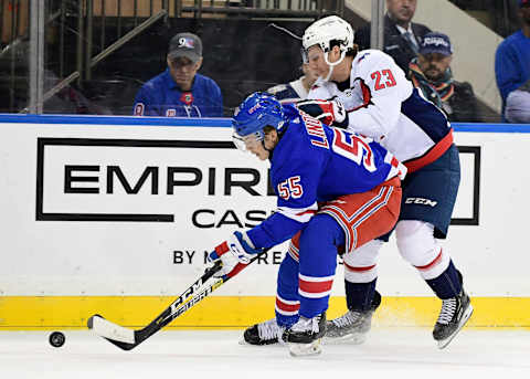 NEW YORK, NEW YORK – NOVEMBER 20: Ryan Lindgren #55 of the New York Rangers and Michael Sgarbossa #23 of the Washington Capitals compete for the puck during their game at Madison Square Garden on November 20, 2019 in New York City. (Photo by Emilee Chinn/Getty Images)