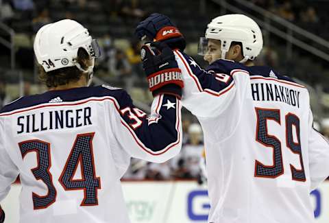 Sep 27, 2021; Pittsburgh, Pennsylvania, USA; Columbus Blue Jackets forward Yegor Chinakhov (59) celebrates with forward Cole Sillinger (34) after scoring a goal against the Pittsburgh Penguins during the first period at PPG Paints Arena. Mandatory Credit: Charles LeClaire-USA TODAY Sports