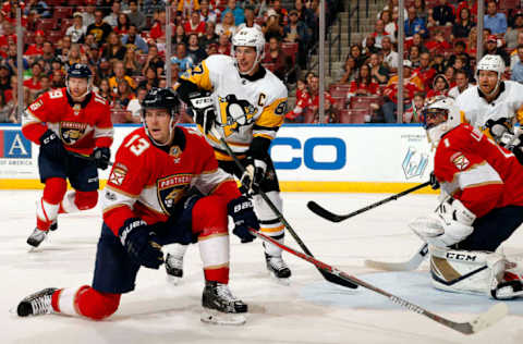 SUNRISE, FL – OCTOBER 20: Mark Pysyk (#13) slides down to block incoming shot from reaching goalie Roberto Luongo (#1).