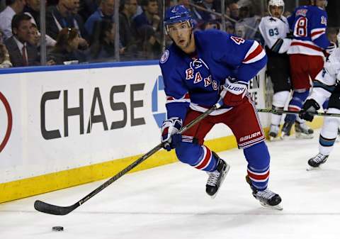 Oct 17, 2016; New York, NY, USA; New York Rangers defenseman Adam Clendening (4) looks to pass the puck against the San Jose Sharks during the first period at Madison Square Garden. Mandatory Credit: Adam Hunger-USA TODAY Sports