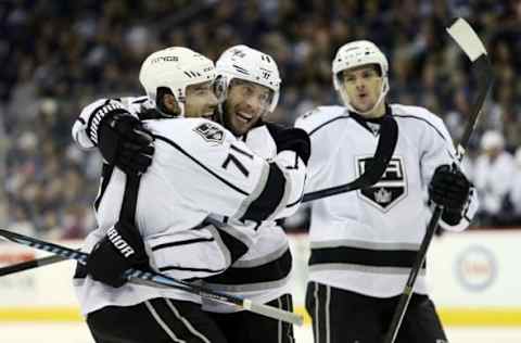 Nov 13, 2016; Winnipeg, Manitoba, CAN; Los Angeles Kings defenseman Tom Gilbert (14) celebrates his goal with center Jordan Nolan (71) during the third period against the Winnipeg Jets at MTS Centre. Winnipeg wins in an overtime shootout 3-2. Mandatory Credit: Bruce Fedyck-USA TODAY Sports