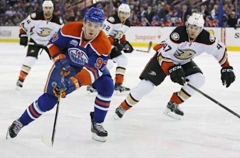 Mar 28, 2016; Edmonton, Alberta, CAN; Edmonton Oilers forward Connor McDavid (97) carries the puck around Anaheim Ducks defensemen Hampus Lindholm (47) during the third periodat Rexall Place. Mandatory Credit: Perry Nelson-USA TODAY Sports