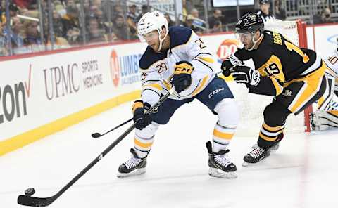 PITTSBURGH, PA – NOVEMBER 19: Jason Pominville #29 of the Buffalo Sabres looks to clear the puck under pressure from Derick Brassard #19 of the Pittsburgh Penguins during the third period in the game at PPG PAINTS Arena on November 19, 2018 in Pittsburgh, Pennsylvania. (Photo by Justin Berl/Getty Images)