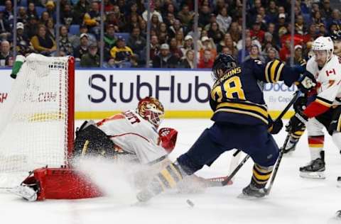 Nov 21, 2016; Buffalo, NY, USA; Calgary Flames goalie Brian Elliott (1) makes a save on Buffalo Sabres center Zemgus Girgensons (28) during the second period at KeyBank Center. Mandatory Credit: Timothy T. Ludwig-USA TODAY Sports