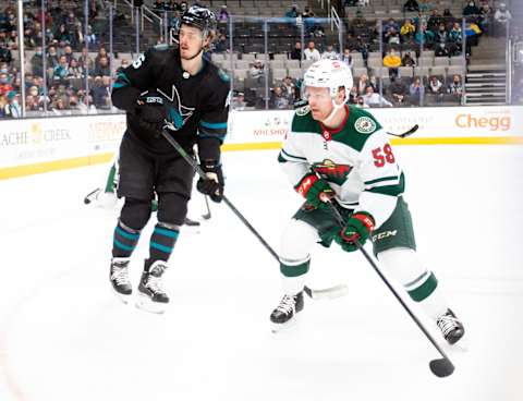 Dec 9, 2021; San Jose, California, USA; Minnesota Wild center Mason Shaw (58) and San Jose Sharks defenseman Erik Karlsson (65) skate during the first period at SAP Center at San Jose. Mandatory Credit: D. Ross Cameron-USA TODAY Sports