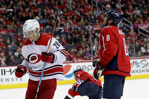 WASHINGTON, DC – MARCH 30: Sebastian Aho #20 of the Carolina Hurricanes celebrates in front of Alex Ovechkin #8 of the Washington Capitals after scoring a third period goal at Capital One Arena on March 30, 2018 in Washington, DC. (Photo by Rob Carr/Getty Images)