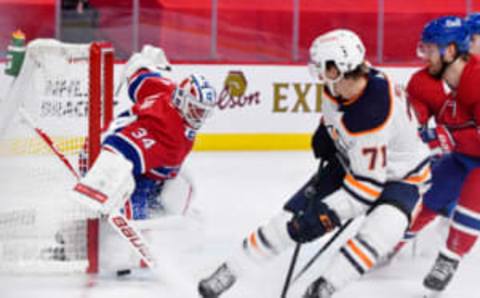 May 10, 2021; Montreal, Quebec, CAN; Montreal Canadiens goalie Jake Allen (34) makes a save in front of Edmonton Oilers forward Ryan McLeod (71) during the third period at the Bell Centre. Mandatory Credit: Eric Bolte-USA TODAY Sports