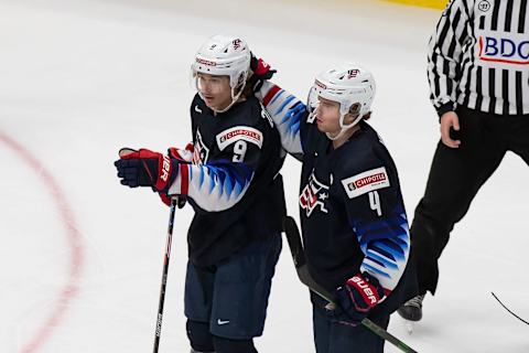 Trevor Zegras #9 and Cam York #4 of the United States. (Photo by Codie McLachlan/Getty Images)