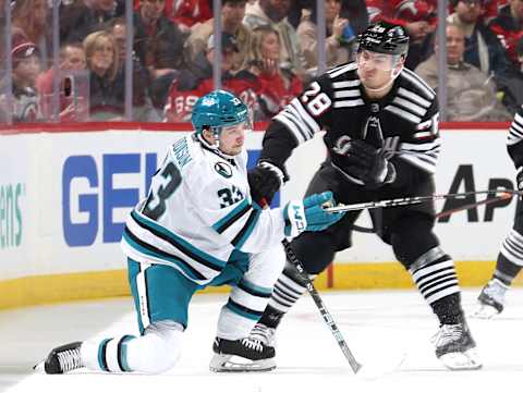 Timo Meier pressures Calen Addison in the Devils’ game against the Sharks. (Photo by Elsa/Getty Images)