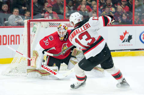 Dec 30, 2015; Ottawa, Ontario, CAN; New Jersey Devils left wing Mike Cammalleri (13) scores against Ottawa Senators goalie Andrew Hammond (30) in the first period at the Canadian Tire Centre. Mandatory Credit: Marc DesRosiers-USA TODAY Sports