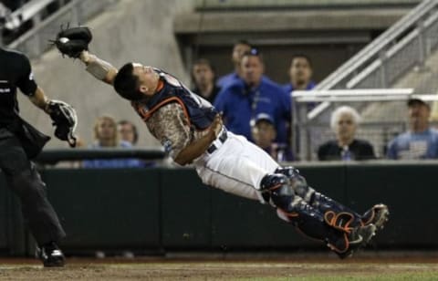 Jun 22, 2015; Omaha, NE, USA; Virginia Cavaliers catcher Matt Thaiss (21) makes a catch for an out during the sixth inning against the Vanderbilt Commodores in game one of the College World Series Finals at TD Ameritrade Park. Mandatory Credit: Bruce Thorson-USA TODAY Sports