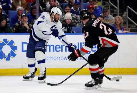 Mar 4, 2023; Buffalo, New York, USA; Tampa Bay Lightning left wing Pat Maroon (14) makes a pass as Buffalo Sabres defenseman Mattias Samuelsson (23) defends during the third period at KeyBank Center. Mandatory Credit: Timothy T. Ludwig-USA TODAY Sports