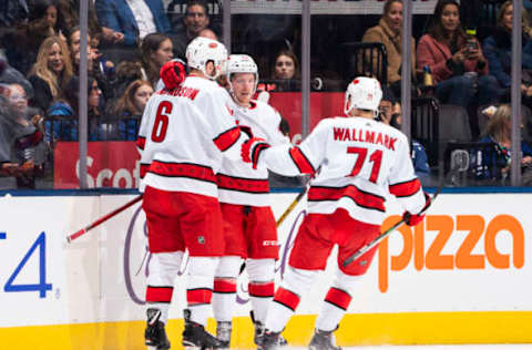 TORONTO, ON – DECEMBER 23: Brock McGinn #23 of the Carolina Hurricanes celebrates his goal against the Toronto Maple Leafs with teammates Lucas Wallmark #71 and Joel Edmundson #6 during the first period at the Scotiabank Arena on December 23, 2019 in Toronto, Ontario, Canada. (Photo by Mark Blinch/NHLI via Getty Images)