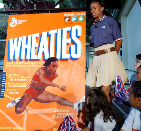 Former Track and Field Olympian Jackie Joyner-Kersey stands with a poster of her new Wheaties box after it was unveiled in 2004.