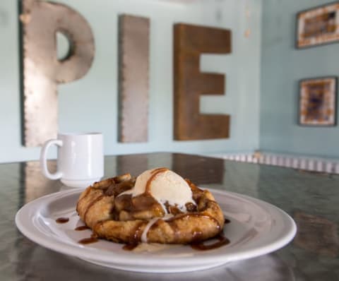 Cowbell's apple pie in front of a sign that says