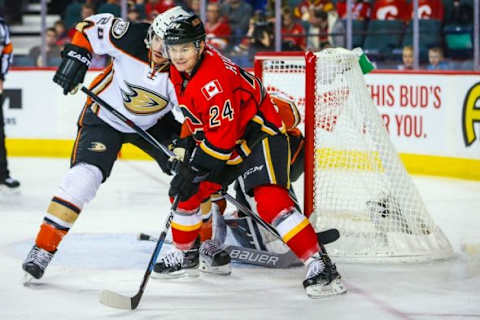 Feb 15, 2016; Calgary, Alberta, CAN; Calgary Flames left wing Jiri Hudler (24) and Anaheim Ducks defenseman Simon Despres (24) fight for position during the first period at Scotiabank Saddledome. Mandatory Credit: Sergei Belski-USA TODAY Sports