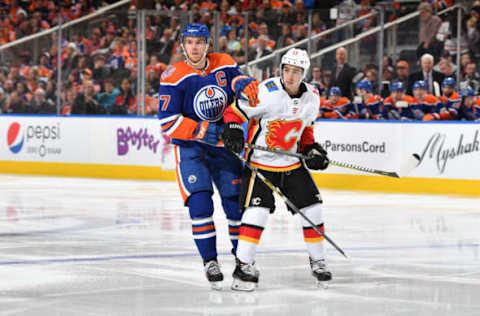 EDMONTON, AB – DECEMBER 9: Connor McDavid #97 of the Edmonton Oilers battles for the puck against Johnny Gaudreau #13 of the Calgary Flames on December 9, 2018 at Rogers Place in Edmonton, Alberta, Canada. (Photo by Andy Devlin/NHLI via Getty Images)