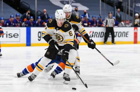 Jun 5, 2021; Uniondale, New York, USA; Boston Bruins defenseman Mike Reilly (6) skates with the puck against New York Islanders center Mathew Barzal (13) during the second period in game four of the second round of the 2021 Stanley Cup Playoffs at Nassau Veterans Memorial Coliseum. Mandatory Credit: Dennis Schneidler-USA TODAY Sports