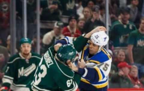 Dec 11, 2016; Saint Paul, MN, USA; Minnesota Wild forward Kurtis Gabriel (63) and St Louis Blues forward Ryan Reaves (75) fight in the first period at Xcel Energy Center. Mandatory Credit: Brad Rempel-USA TODAY Sports