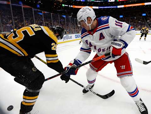 Apr 23, 2022; Boston, Massachusetts, USA; New York Rangers center Ryan Strome (16) and Boston Bruins defenseman Brandon Carlo (25) fight for a loose puck during the third period at TD Garden. Mandatory Credit: Winslow Townson-USA TODAY Sports