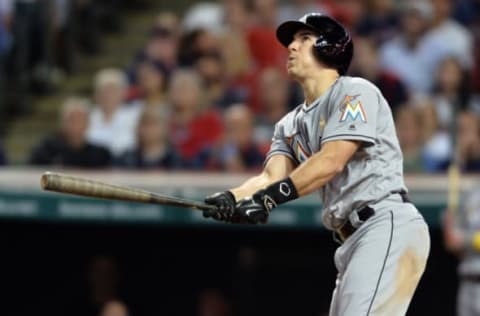 Sep 2, 2016; Cleveland, OH, USA; Miami Marlins catcher J.T. Realmuto (11) hits a home run during the eighth inning against the Cleveland Indians at Progressive Field. Mandatory Credit: Ken Blaze-USA TODAY Sports