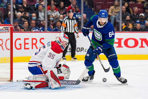 Mar 9, 2022; Vancouver, British Columbia, CAN; Vancouver Canucks forward Tyler Motte (64) looks for the rebound as Montreal Canadiens goalie Sam Montembeault (35) makes a save in the third period at Rogers Arena. Canucks won 5-3. Mandatory Credit: Bob Frid-USA TODAY Sports