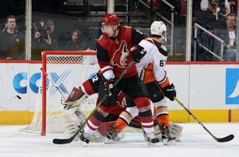 GLENDALE, AZ: The puck is shot wide of the goal as Luke Schenn #2 of the Arizona Coyotes battles in front of the net with Rickard Rakell #67 of the Anaheim Ducks on April 7, 2018. (Photo by Norm Hall/NHLI via Getty Images)