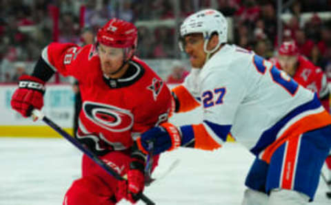 Apr 25, 2023; Raleigh, North Carolina, USA; Carolina Hurricanes left wing Mackenzie MacEachern (28) and New York Islanders left wing Anders Lee (27) battle for position during the third period in game five of the first round of the 2023 Stanley Cup Playoffs at PNC Arena. Mandatory Credit: James Guillory-USA TODAY Sports