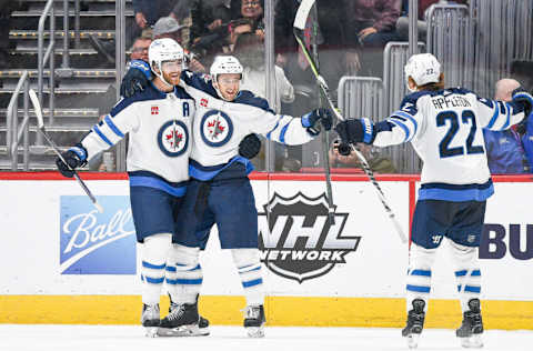 DENVER, COLORADO - OCTOBER 19: Neal Pionk #4 of the Winnipeg Jets celebrates a game-winning overttime goal with teammates Adam Lowry #17 and Mason Appleton #22 against the Colorado Avalanche an at Ball Arena on October 19, 2022 in Denver, Colorado. (Photo by Dustin Bradford/Getty Images)