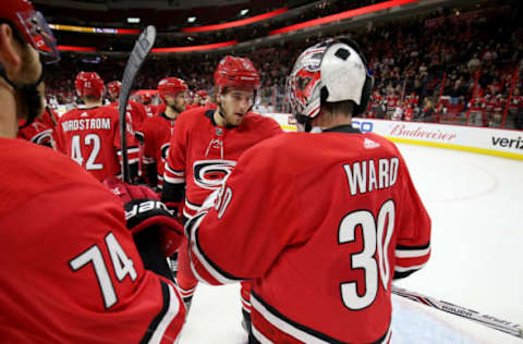 RALEIGH, NC – JANUARY 30: Cam Ward #30 of the Carolina Hurricanes is congratulated by teammate Noah Hanifin #5 after a victory over the Ottawa Senators following an NHL game on January 30, 2018 at PNC Arena in Raleigh, North Carolina. (Photo by Gregg Forwerck/NHLI via Getty Images)