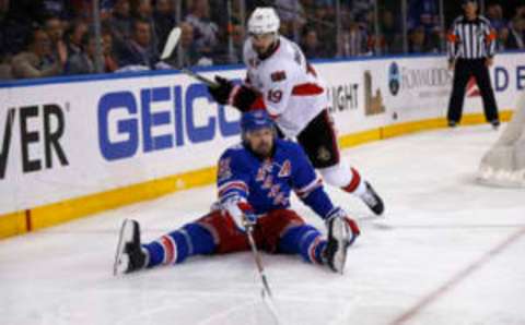 New York Rangers left wing Rick Nash (61) passes the puck in front of Ottawa Senators center Derick Brassard (19) (Adam Hunger-USA TODAY Sports)