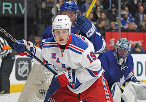 Jesper Fast of the New York Rangers skates against Morgan Rielly of the Toronto Maple Leafs while Frederik Andersen looks on (Photo by Claus Andersen/Getty Images)