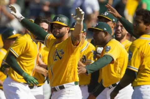 May 7, 2017; Oakland, CA, USA; Oakland Athletics first baseman Yonder Alonso (17) celebrates with his team after a walk off two run home run by Athletics designated hitter Ryan Healy (not pictured) against the Detroit Tigers at Oakland Coliseum. The Athletics won 8-6. Mandatory Credit: Andrew Villa-USA TODAY Sports