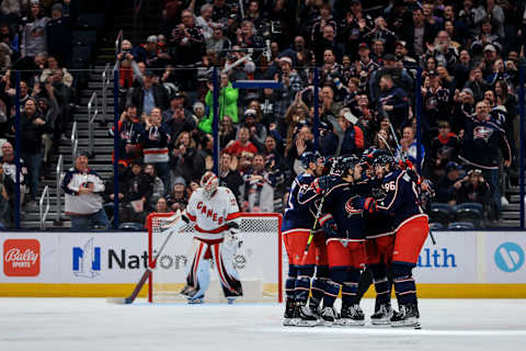 Jan 7, 2023; Columbus, Ohio, USA; Columbus Blue Jackets right wing Kirill Marchenko (right) celebrates with teammates after scoring his hat-trick goal against the Carolina Hurricanes in the third period at Nationwide Arena. Mandatory Credit: Aaron Doster-USA TODAY Sports