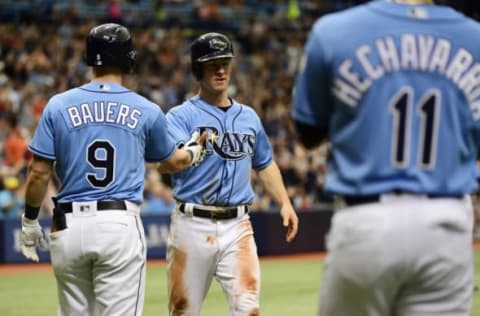 ST PETERSBURG, FL – JULY 1: Joey Wendle #18 of the Tampa Bay Rays celebrates with Jake Bauers #9 and Adeiny Hechavarria #11 after scoring in the seventh inning against the Houston Astros on July 1, 2018 at Tropicana Field in St Petersburg, Florida. (Photo by Julio Aguilar/Getty Images)