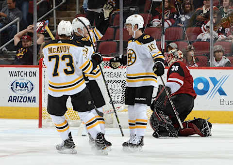 GLENDALE, AZ – OCTOBER 14: Anders Bjork #10, Charlie McAvoy #73 and Danton Heinen #43 of the Boston Bruins celebrate a third period goal against Louis Domingue #35 of the Arizona Coyotes at Gila River Arena on October 14, 2017 in Glendale, Arizona. Bruins won 6-2. (Photo by Norm Hall/NHLI via Getty Images)