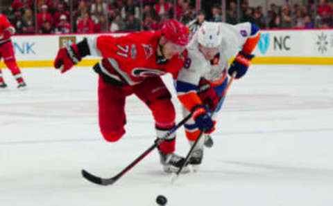 Apr 19, 2023; Raleigh, North Carolina, USA; Carolina Hurricanes right wing Jesper Fast (71) and New York Islanders defenseman Noah Dobson (8) chase after the puck during the third period in game two of the first round of the 2023 Stanley Cup Playoffs at PNC Arena. Mandatory Credit: James Guillory-USA TODAY Sports