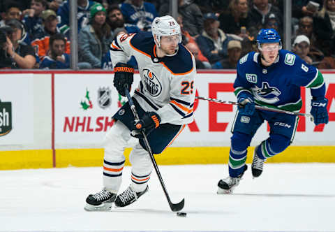 VANCOUVER, BC – DECEMBER 01: Leon Draisaitl #29 of the Edmonton Oilers skates with the puck while Brock Boeser #6 of the Vancouver Canucks gives chase during NHL action at Rogers Arena on December 1, 2019 in Vancouver, Canada. (Photo by Rich Lam/Getty Images)