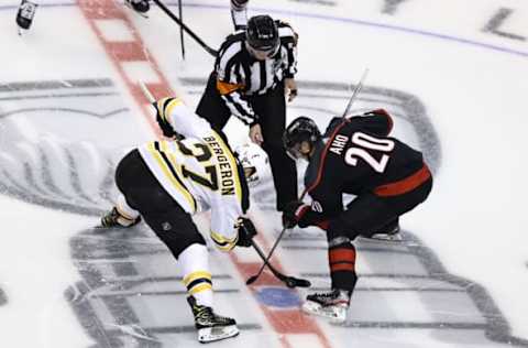 Patrice Bergeron #37 of the Boston Bruins and Sebastian Aho #20 of the Carolina Hurricanes. (Photo by Elsa/Getty Images)