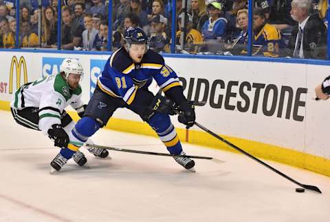 May 9, 2016; St. Louis, MO, USA; Dallas Stars defenseman Kris Russell (2) reaches for the puck on St. Louis Blues right wing Vladimir Tarasenko (91) during the second period in game six of the second round of the 2016 Stanley Cup Playoffs at Scottrade Center. Mandatory Credit: Jasen Vinlove-USA TODAY Sports