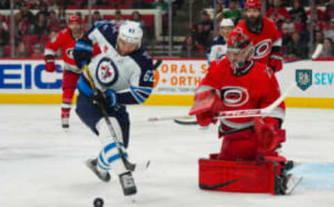 Mar 14, 2023; Raleigh, North Carolina, USA; Winnipeg Jets right wing Nino Niederreiter (62) goes for the rebound against Carolina Hurricanes goaltender Frederik Andersen (31) during the second period at PNC Arena. Mandatory Credit: James Guillory-USA TODAY Sports