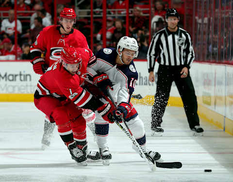 RALEIGH, NC – OCTOBER 10: Derek Ryan #7 of the Carolina Hurricanes and Alexander Wennberg #10 of the Columbus Blue Jackets struggle for possession of the puck during an NHL game on October 10, 2017 at PNC Arena in Raleigh, North Carolina. (Photo by Gregg Forwerck/NHLI via Getty Images)