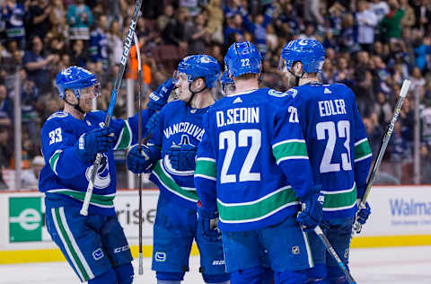 VANCOUVER, BC – MARCH 17: Vancouver Canucks Center Henrik Sedin (33) and Center Bo Horvat (53) and Left Wing Daniel Sedin (22) and Defenseman Alexander Edler (23) celebrate Edler’s goal against the San Jose Sharks during the second period in a NHL hockey game on March 17, 2018, at Rogers Arena in Vancouver, BC. (Photo by Bob Frid/Icon Sportswire via Getty Images)