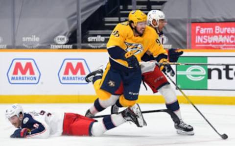 Jan 16, 2021; Nashville, Tennessee, USA; Nashville Predators center Matt Duchene (95) is hit by Columbus Blue Jackets defenseman Zach Werenski (8) and defenseman Seth Jones (3) as he skates toward the net during the third period at Bridgestone Arena. Mandatory Credit: Christopher Hanewinckel-USA TODAY Sports