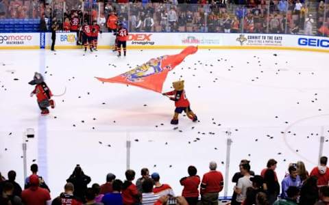 Mar 31, 2016; Sunrise, FL, USA; Florida Panthers mascots celebrate a 3-2 win over the New Jersey Devils as plastic rats cover the ice at BB&T Center. Ten thousand rats were given to fans resulting in the team being penalized twice for delay of game. Mandatory Credit: Robert Mayer-USA TODAY Sports