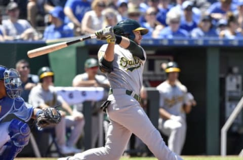 Oakland Athletics’ Jed Lowrie follows through on an RBI single in the eighth inning to score Dustin Fowler from second against the Kansas City Royals on Sunday, June 3, 2018, at Kauffman Stadium in Kansas City, Mo. (John Sleezer/Kansas City Star/TNS via Getty Images)